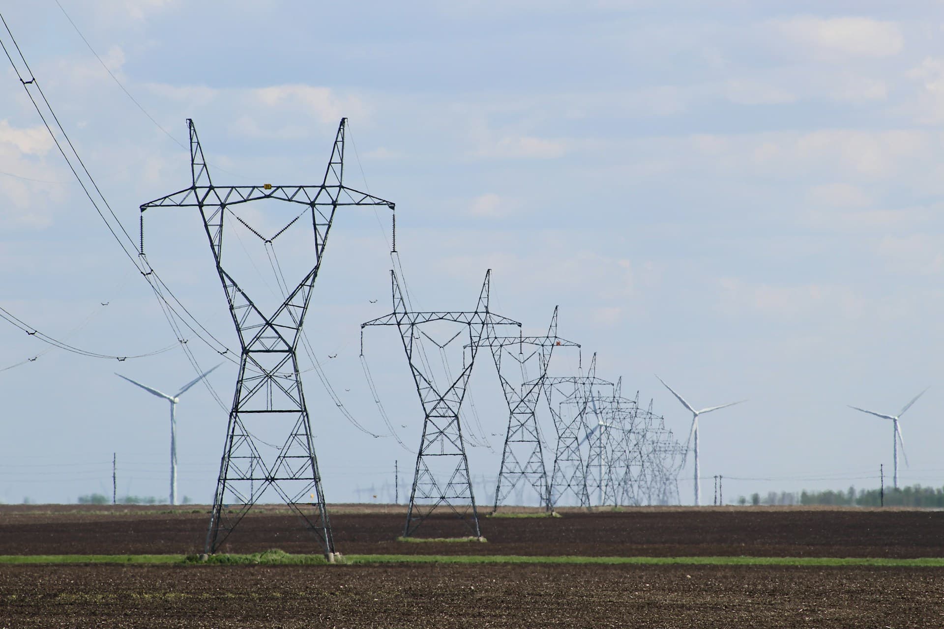 Drone inspecting a high-voltage transmission tower